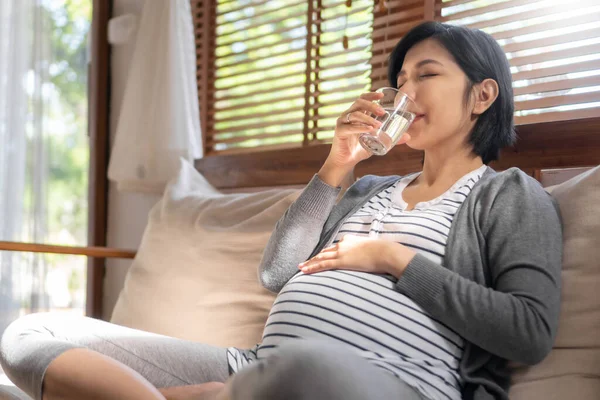 Ung Asiatisk Gravid Kvinna Sitter Soffan Dricker Rent Färskt Glas — Stockfoto