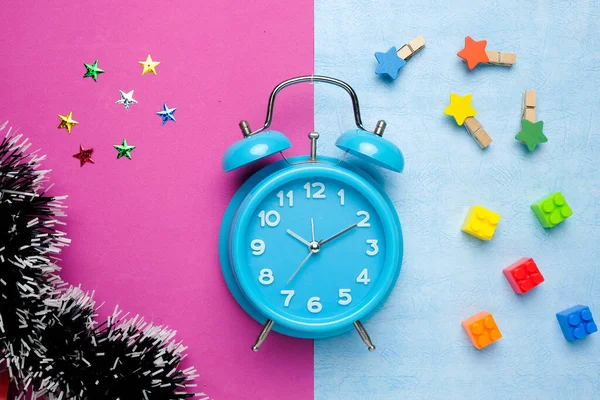 Flatlay Picture Alarm Clock Pink Blue Background Building Block Tinsel — Stock Photo, Image