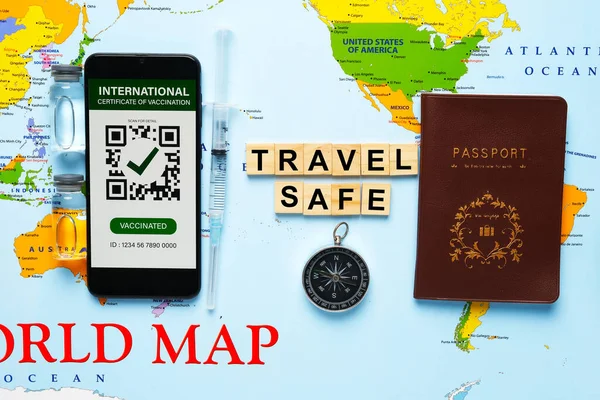 A picture of passport, International Certificate of Vaccination, vaccine bottle, compass and compass with travel safe word on world map