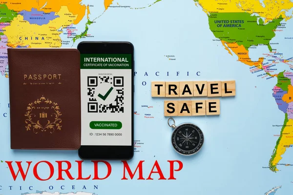 A picture of passport and International Certificate of Vaccination with travel safe word on world map