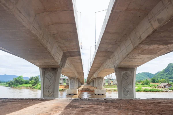 Perspective construction from under the new bridge. The bridge over the Maekok river at Chiang Rai, Thailand