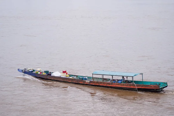 Longtail boat carrying consumer goods on the Mekong River in Chiang Saen, Chiang Rai province, Thailand. Landscape beautiful of nature. Space for text