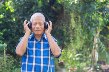 Kısa beyaz saçlı, kablosuz kulaklık takan, bahçedeyken en sevdiği şarkıyı dinleyen son sınıf öğrencisi. Mesaj için yer var. Yaşlılar ve rahatlama kavramı