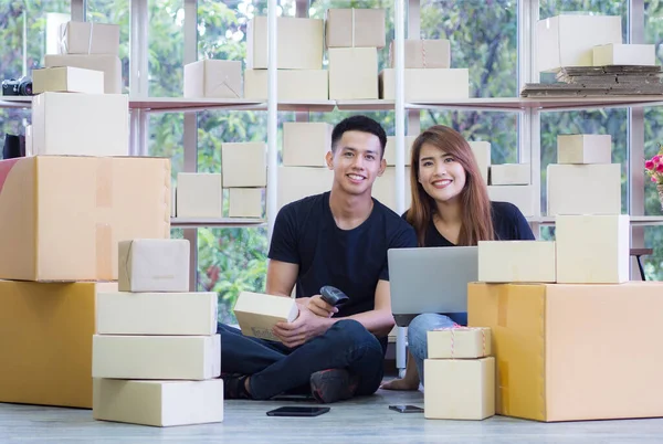 Young couple are new ecommerce entrepreneurs, working as a teamwork and using internet for the business efficiency whether it is a website and various social media. Startup business concept