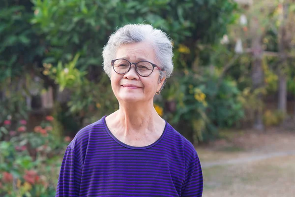 Retrato Una Anciana Con Anteojos Sonriendo Mirando Cámara Mientras Está — Foto de Stock