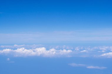 Uçak penceresinden görülen bulutlu hava manzarası. Metin için boşluk.
