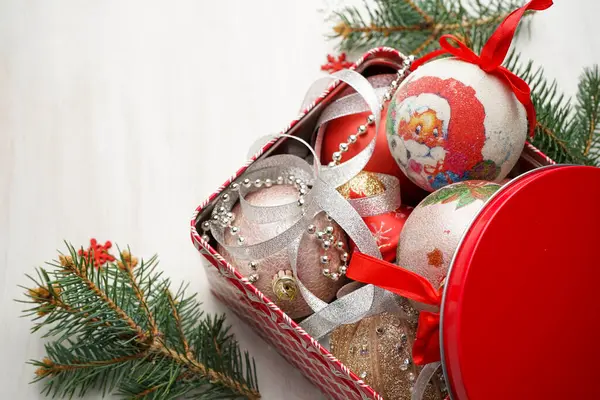 Świąteczna Kartka Czerwonym Pudełkiem Wypełnionym Zabawkami Choinkowymi Otoczonymi Gałęziami Choinki — Zdjęcie stockowe
