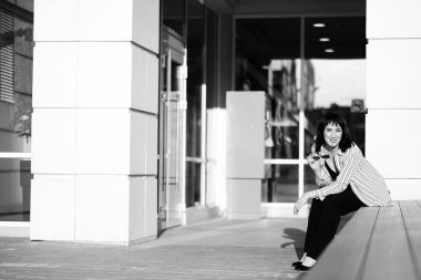 Şirket fotoshop 'u için fotoğraf çeken kadın patron, işinde başarılı bir kadın. Yazın alışveriş merkezinin yakınındaki siyah beyaz fotoğraf.