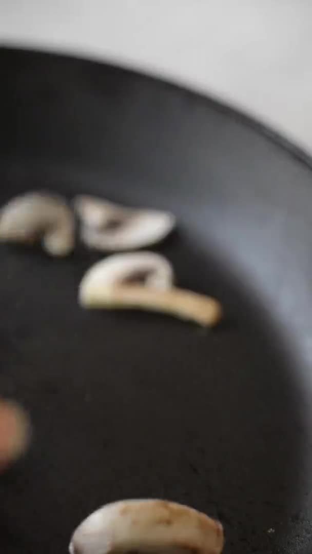 Vertical Video Frying Fresh Mushrooms Black Pan Pour Chopped Mushrooms — Stock Video