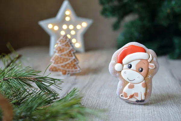 Noel boğası şeklinde zencefilli çörekler, 2021 Noel sembolleri, beyaz bir masa üzerinde yeni yıl dekoru, yatay.