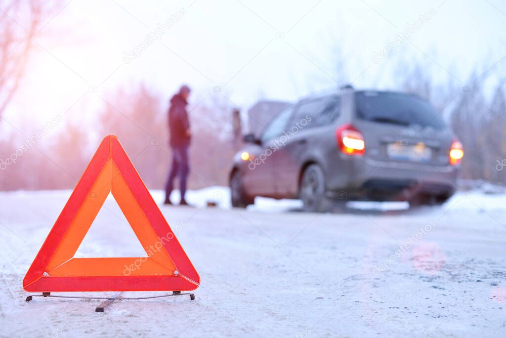 car repair on the road in winter. Car triangle on winter road. Problem with vehicle on snowy road. Broken cars concept. banner of snowy winter road