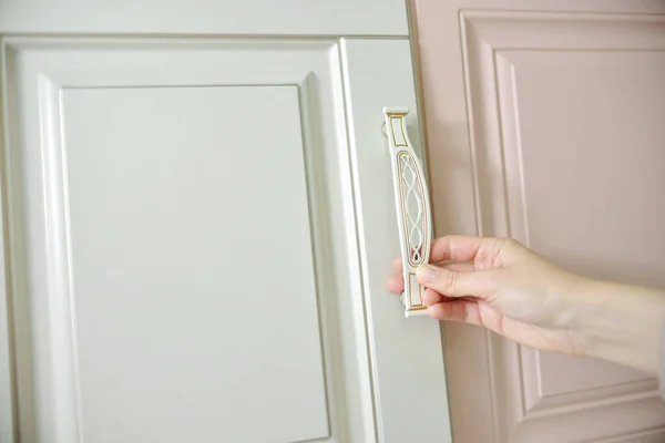 Ev geliştirme konsepti. Tasarımcı kız vitrindeki mobilyaların ön cephelerini ve kollarını seçiyor. Mobilya endüstrisinde dekorasyon tahtaları. Madde örnekleri seçiliyor.