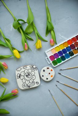 Gıda boyalı zencefilli kek. Çocuklar için bir boyama kitabı gri bir masada yatıyor. Bir çocuk için orijinal yenilebilir hediye konsepti.