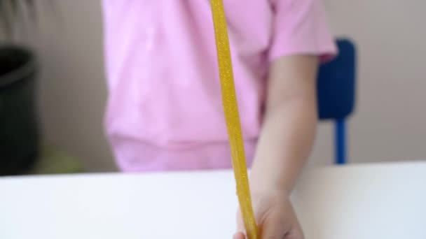 Close Uma Menina Segurar Alongamento Amarelo Com Brilho Dourado Lodo — Vídeo de Stock