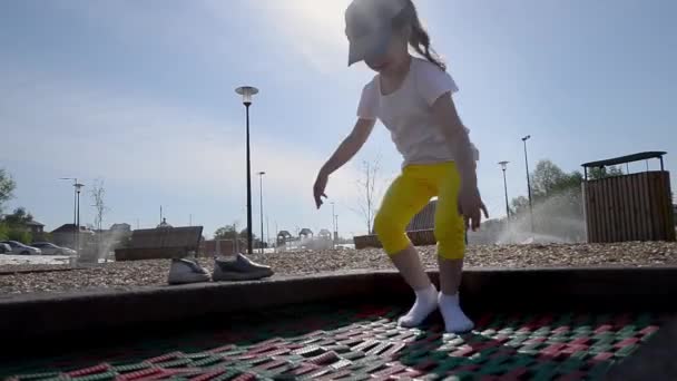 Girl Yellow Shertas White Shirt Jumps Trampoline Street Early Summer — Stock Video