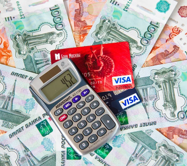 Credit card calculator lying on Russian money — Stock Photo, Image