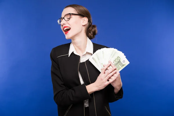 Woman in a dark suit and with money in hand — Stock Photo, Image