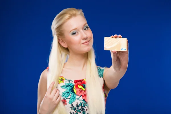 Young girl with a credit card in focus — Stock Photo, Image