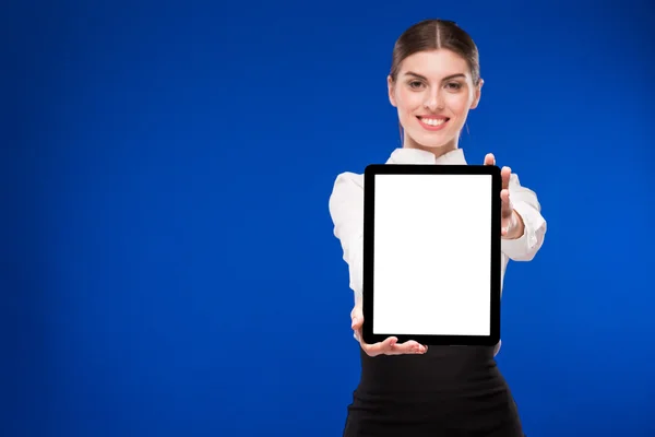 Woman with a tablet in focus on a blue background Royalty Free Stock Images