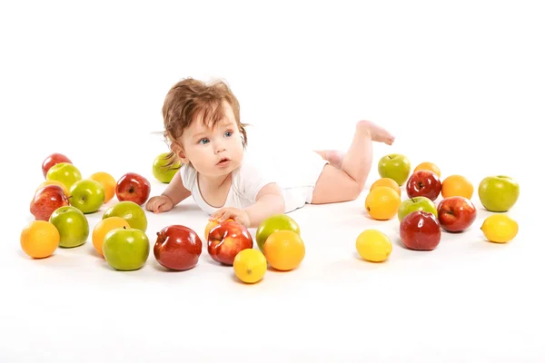 Little boy surrounded by fruit — Stock Photo, Image