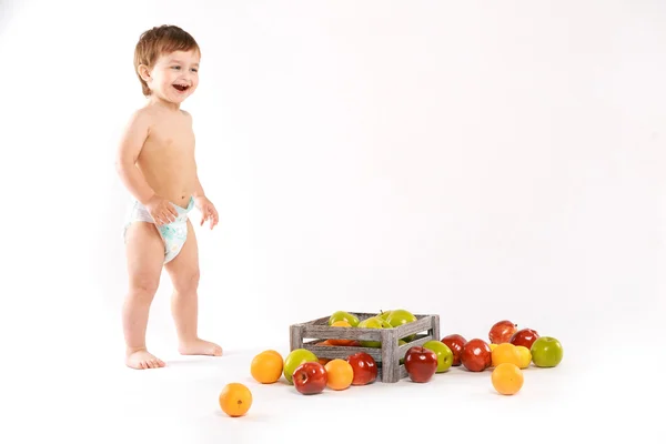 Baby laughing with fruit — Stock Photo, Image