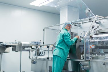 Işleç Fabrika iş içinde belgili tanımlık makine kontrol eder.