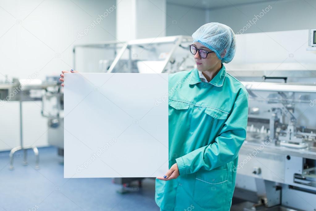 pharmaceutical factory worker shows Equipment