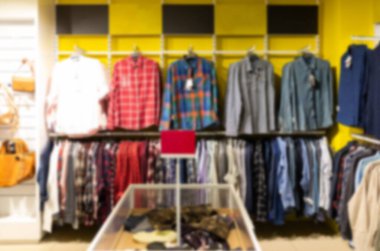 clothing store with a large assortment of shirts, blurred and defocused