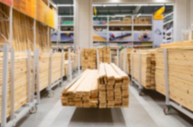 hardware store: shelving with large wooden boards, blurred and defocused
