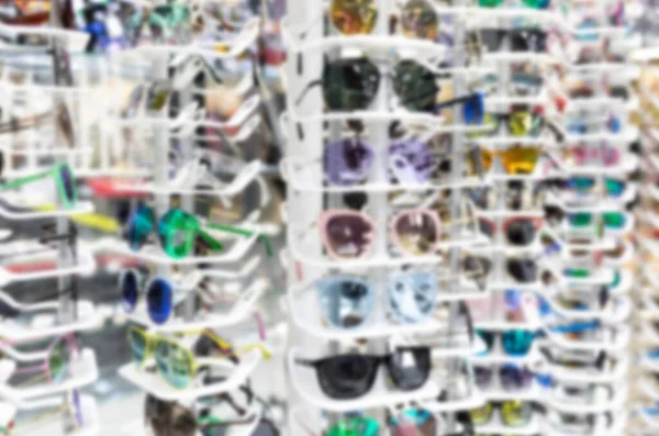 Blurred store of stylish accessories for sight, a large selection of frames — Stock fotografie