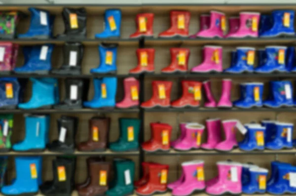 childrens bright shoe store with a large selection of colors, models and sizes, blurred and defocused
