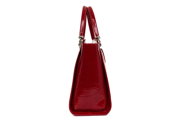 Red stylish ladies leather bag on a white background, side view — стоковое фото