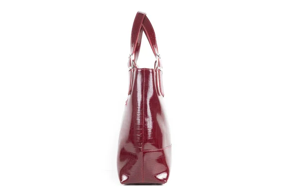 Red stylish ladies leather bag on a white background, side view — стоковое фото