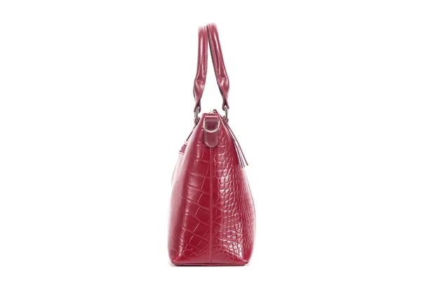 Red stylish ladies leather bag on a white background, side view — стоковое фото