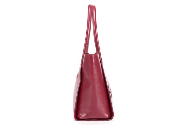 Red stylish ladies leather bag on a white background, side view — стоковое фото