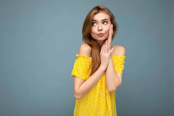 Young cute beautiful dark blonde woman with sincere emotions isolated on background wall with copy space wearing stylish yellow dress. Positive concept — Stock Photo, Image