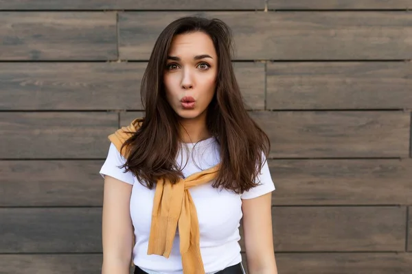 Photo of emotional positive happy joyful pretty young brunette woman in trendy outfit. Beautiful attractive female person standing outside in the street and showing sincere emotions — Stock Photo, Image