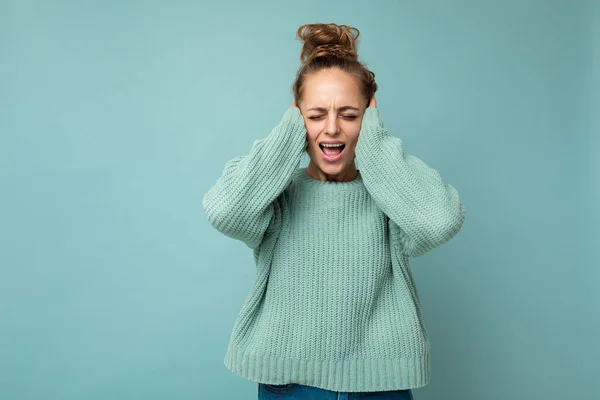Retrato de una joven mujer rubia atractiva emocional con emociones sinceras que lleva camiseta azul casual aislada sobre fondo azul con espacio vacío y gritando — Foto de Stock