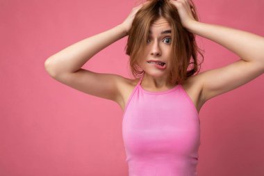 Genç, güzel, esmer, sarışın, samimi duyguları olan, arka plan duvarında izole edilmiş, fotokopi alanı olan, şık pembe bluz giyen genç bir kadın. Pozitif kavram