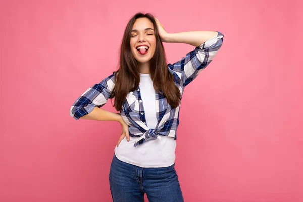 Photo shot of cute nice charming gorgeous attractive pretty youngster happy woman wearing stylish clothes isolated over colorful background with copy space and showing tongue — Stock Photo, Image