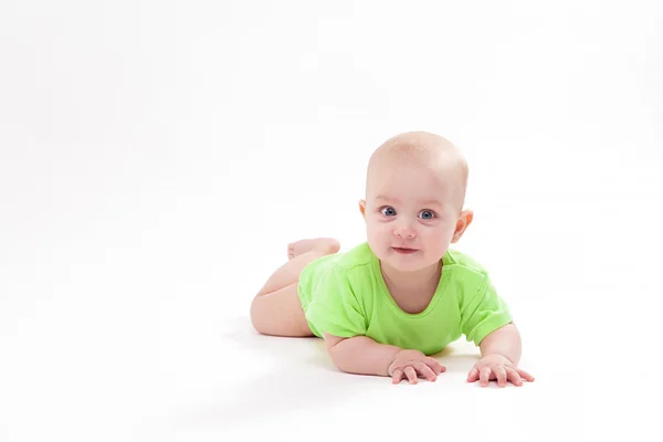 Smiling baby lying on his stomach and looking at the camera — Stock Photo, Image