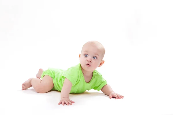 Surprised cute baby lying on his stomach and looking at the came — Stock Photo, Image