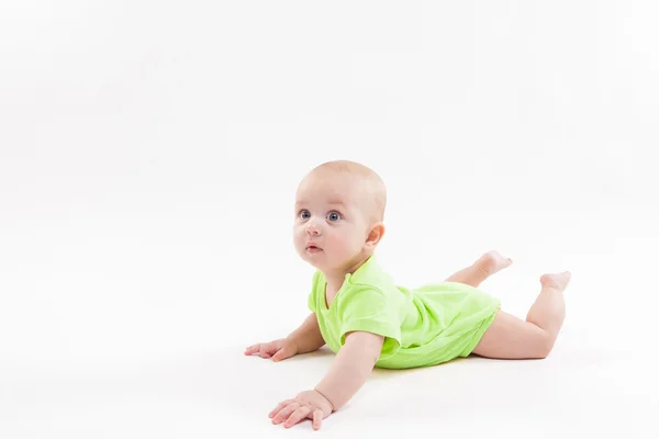 Surprised cute baby lying on his stomach and looking at the came — Stock Photo, Image