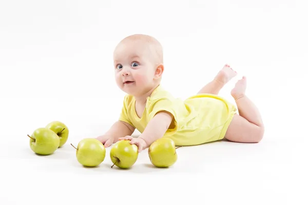 Cute curious baby lies on her stomach and looking at the camera — Stock Photo, Image