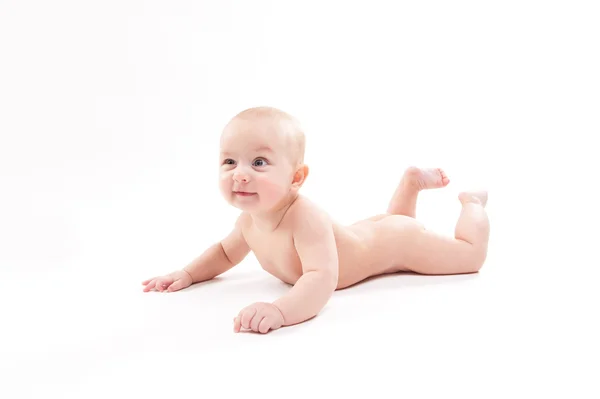 Naked baby on a white background smiling and looking at the came — Stock Photo, Image