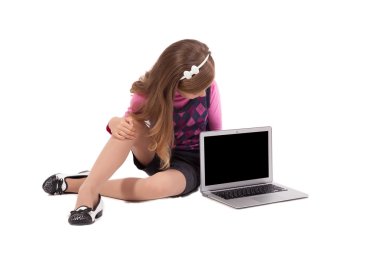 schoolgirl on a white background looking into the laptop and smi