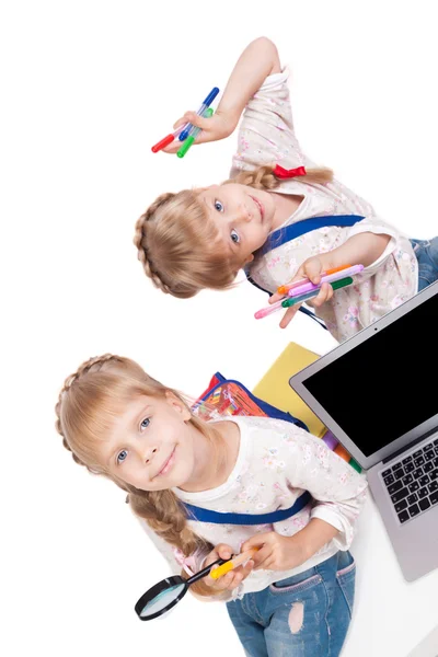 Two cheerful girls twins having fun on a white background surrou — ストック写真