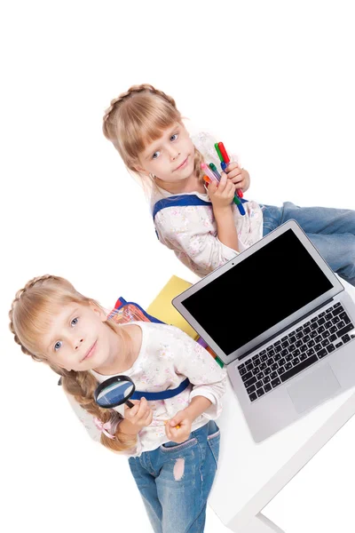 Two cheerful girls twins having fun on a white background surrou — ストック写真