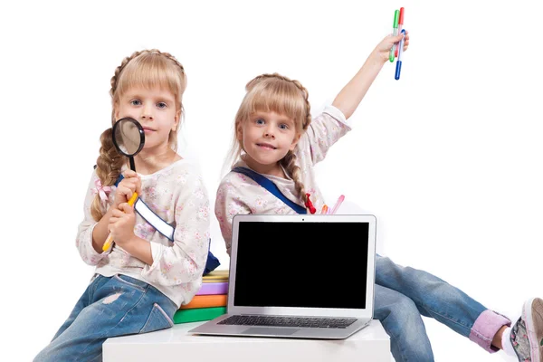 Two cheerful girls twins having fun on a white background surrou — ストック写真