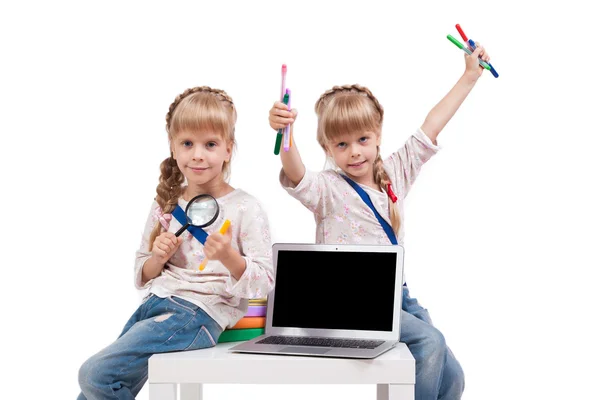 Two cheerful girls twins having fun on a white background surrou — ストック写真